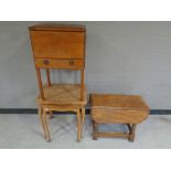 An oak work table together with a small drop leaf table and a nest of two tables