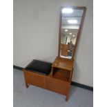 A teak telephone seat together with a teak framed wall mirror