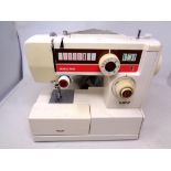 A Riccar electric sewing machine with foot pedal