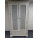 A contemporary painted double door wardrobe fitted drawer beneath