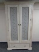 A contemporary painted double door wardrobe fitted drawer beneath