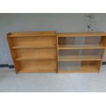 A set of mid 20th century sliding glass door bookshelves together with a further set of open