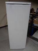 A upright freezer.