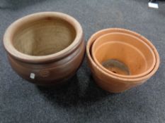A glazed pottery circular planter together with two terracotta planters