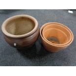 A glazed pottery circular planter together with two terracotta planters