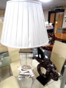 A contemporary metal and glass table lamp with shade together with a further contemporary figure,