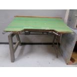 A industrial draftsmen's table on metal legs.