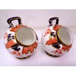 A Pair of Royal Crown Derby Imari Fern pattern salt pigs, height 9 cm.