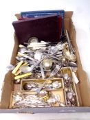 A box containing large quantity of boxed and unboxed table cutlery to include knives, teaspoons,