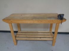 A pine two-tier work bench fitted a vice.