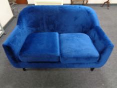 A contemporary two seater settee in blue upholstery