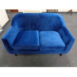 A contemporary two seater settee in blue upholstery