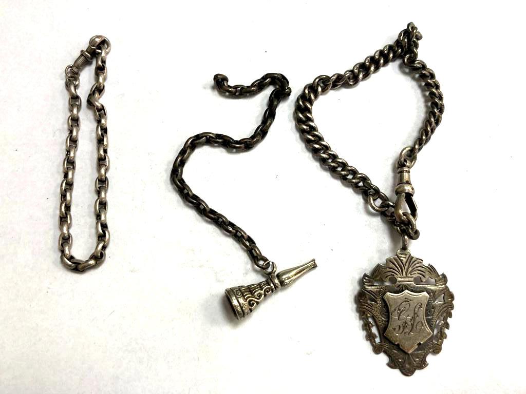 A silver Albert chain with fob and two other chains