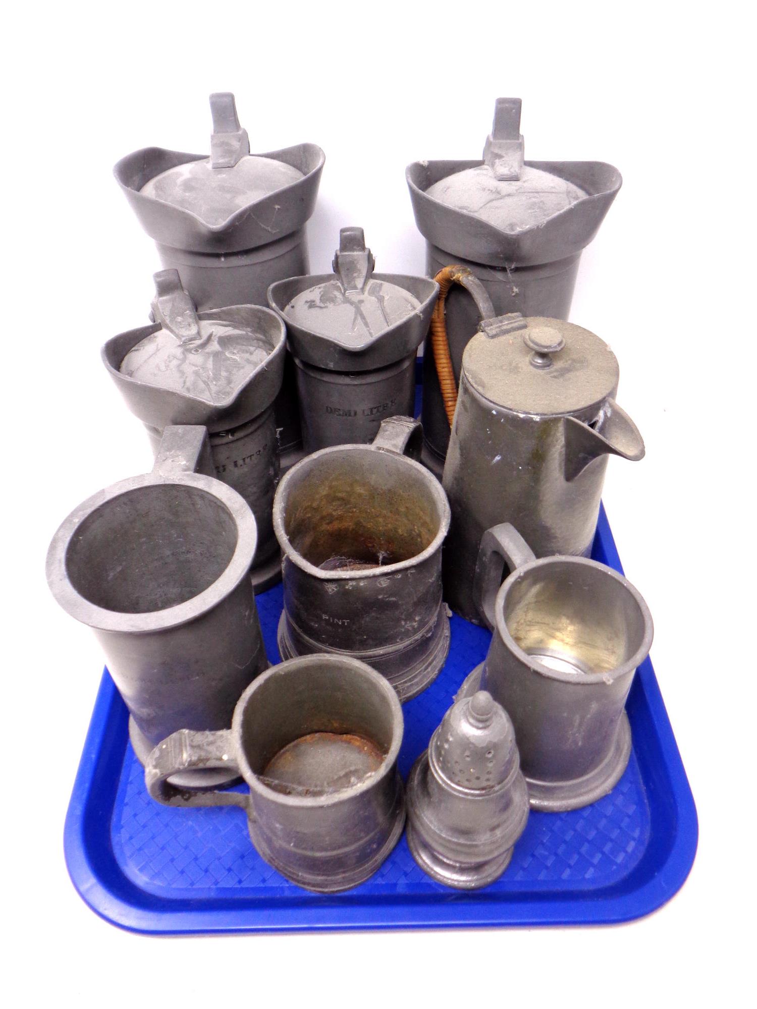 A tray containing ten pieces of antique and later pewter to include measuring jug, tankards,