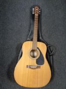 A Yamaha F-310 acoustic guitar in carry bag