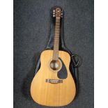 A Yamaha F-310 acoustic guitar in carry bag