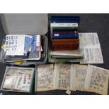 A luggage case and a box containing stamp albums containing stamps of the world, loose stamps,