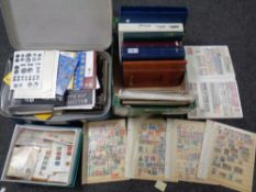 A luggage case and a box containing stamp albums containing stamps of the world, loose stamps,