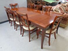 A good quality mahogany extending dining table with two leaves together with a set of eight chairs,