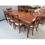 A good quality mahogany extending dining table with two leaves together with a set of eight chairs,