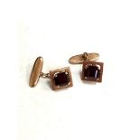 A pair of 14ct gold cufflinks set with garnets CONDITION REPORT: 7.