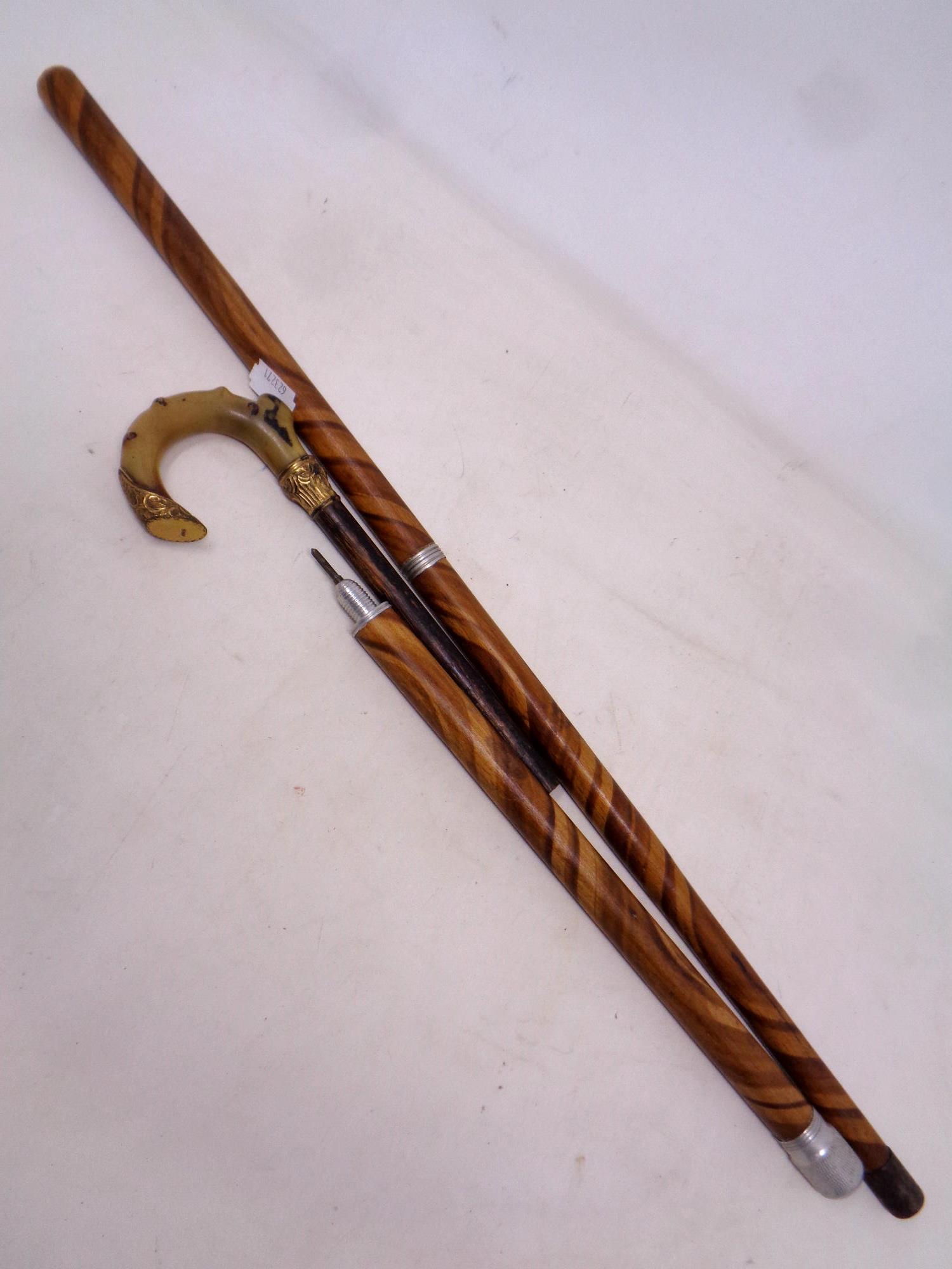 An early 20th century sectional walking stick with internal fountain pen and pencil.