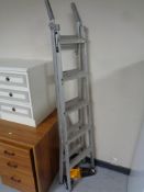 A set of Abru aluminium 3-in-1 ladders together with a JCB hand held vacuum.