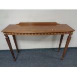 A reproduction mahogany bowfront hall table