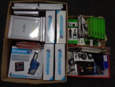 Two boxes containing Vibe phone charger, phone covers, mini portable speaker,