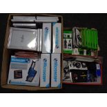 Two boxes containing Vibe phone charger, phone covers, mini portable speaker,