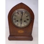 A late 19th century inlaid mahogany arch top eight day mantel clock with silvered dial