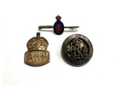 A group of silver badges including ARP, Punjab regiment,