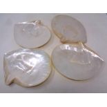 A set of four mother of pearl shell dishes