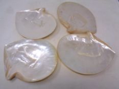 A set of four mother of pearl shell dishes