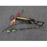 A crossbow with bolts together with an archery bow with arrows