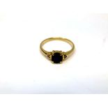 An 18ct yellow gold sapphire and two stone diamond ring, size M/N, 2.1g.