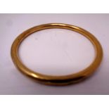 A 9ct gold circular bangle (dented) CONDITION REPORT: 11.