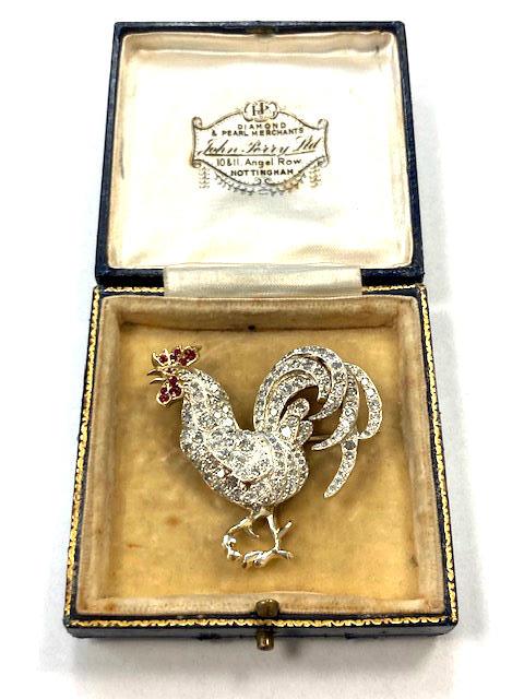 A fine quality antique diamond brooch modelled as a cockerel, set with red stones,