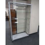 A contemporary metal and glass display cabinet fitted four glass shelves internally