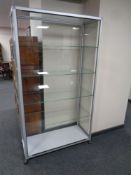 A contemporary metal and glass display cabinet fitted four glass shelves internally