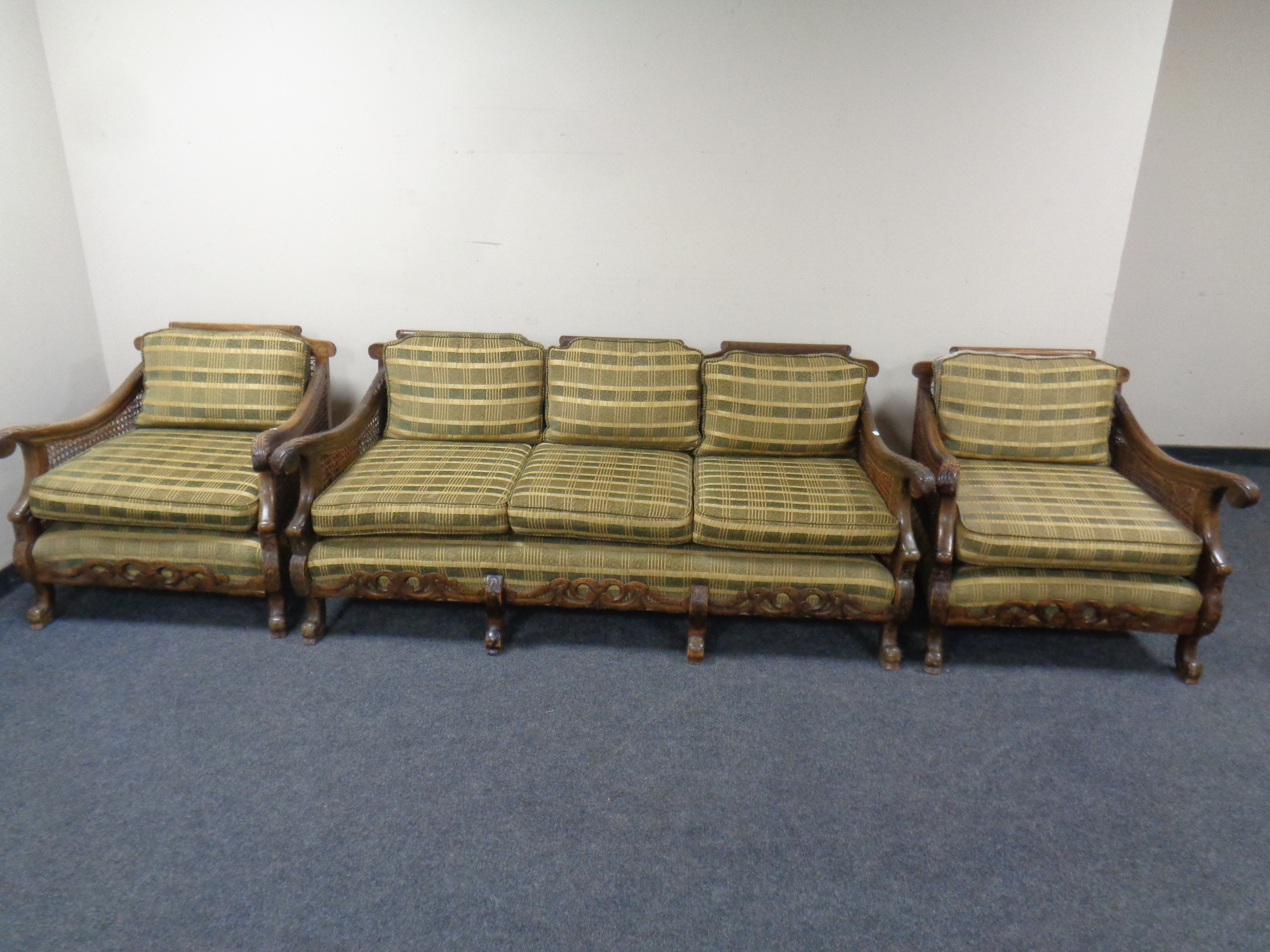 A carved beech bergere three piece lounge suite