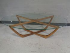 A mid 20th century oval glass topped coffee table on teak base.