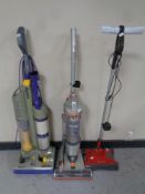 A Dyson DC3 upright vacuum together with a VAX Air3 upright vacuum and a G Tech cordless carpet