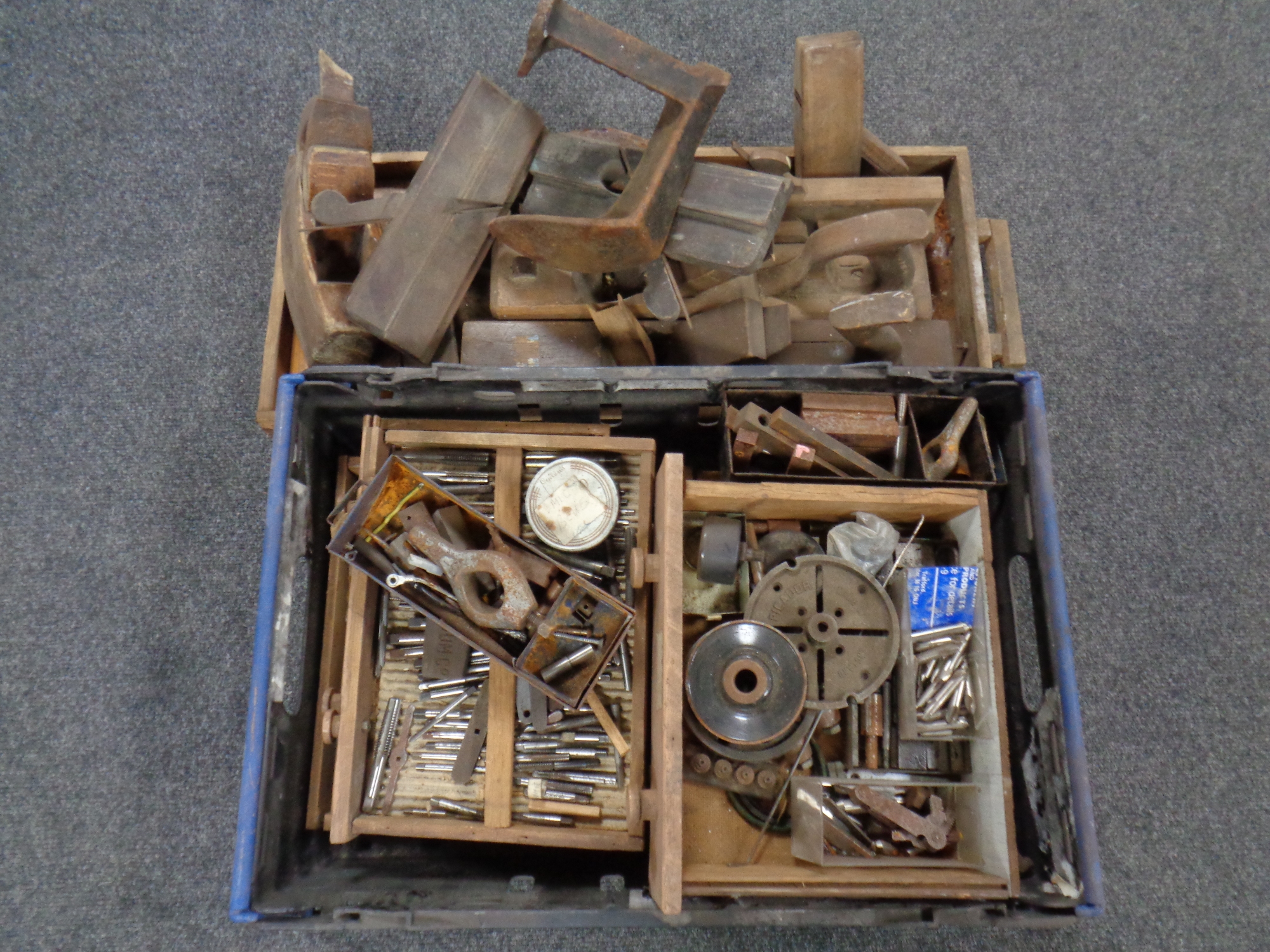 A wooden tray and a crate containing a large quantity of wooden joinery tools, cobbler's last,