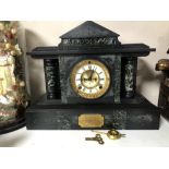 A late 19th century black slate and marble mantel clock by the Ansonia Clock Company with brass