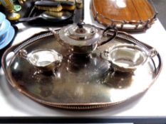 A large oval silver plated gallery tray together with a three piece plated tea service.