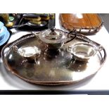 A large oval silver plated gallery tray together with a three piece plated tea service.