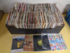 A box containing a large quantity of vinyl 7" singles to include David Bowie, Mick Jagger,