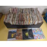 A box containing a large quantity of vinyl 7" singles to include David Bowie, Mick Jagger,