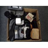 A box containing Zeiss projector, camera equipment, cameras, lenses cases,